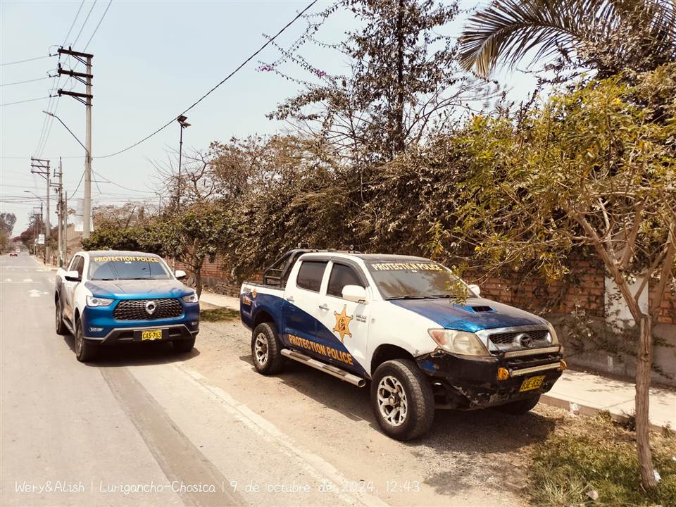Dos camionetas de Protection Police estacionadas en una calle de Lurigancho-Chosica.